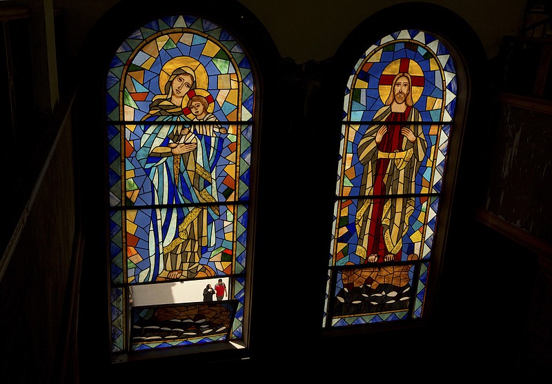 
              People are seen through the stain glass, of the Coptic church of Mar Girgis, in Cairo, Egypt, Monday, April 24, 2017. Pope Francis is scheduled to make a two-day pilgrimage to Egypt, a predominantly Muslim Arab nation where on April 9, on the Christian holy day of Palm Sunday, twin suicide bombings of Coptic churches killed 44 people. (AP Photo/Amr Nabil)
            