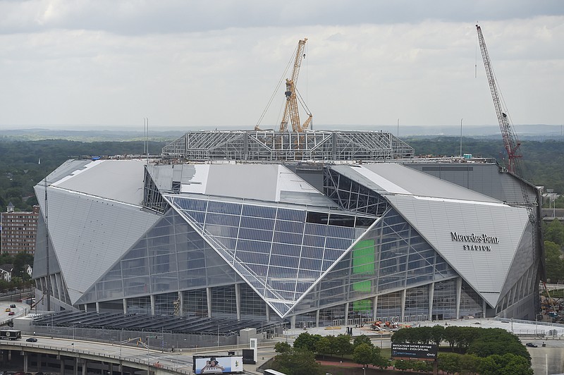 
              FILE -In this Tuesday, April 18, 2017 file photo, large cranes loom over the construction at the new Mercedes Benz Stadium, in Atlanta. The planned opening of the $1.5 billion stadium has been delayed. Stadium general manager Scott Jenkins told The Associated Press on Tuesday, April 25, 2017,  that the building is 90 percent done, but the biggest holdup has been roof construction. (AP Photo/Mike Stewart, File)
            