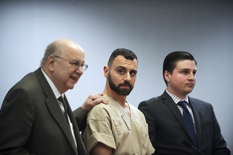 
              FILE - In this Monday, April 17, 2017, file photo, Richard Dabate, center, appears with attorneys Hubie Santos, left, and Trent LaLima, right, while being arraigned, in Rockville Superior Court in Vernon, Conn. Authorities said Dabate told them a masked man had entered their home Dec. 23, 2015, shot his wife and tied him up before he burned the intruder with a torch. But the New York Daily News reported the Connecticut State Police wrote in an arrest warrant that his wife’s Fitbit was logging steps after the time Dabate told them she was killed. (Mark Mirko/Hartford Courant via AP, Pool, File)
            