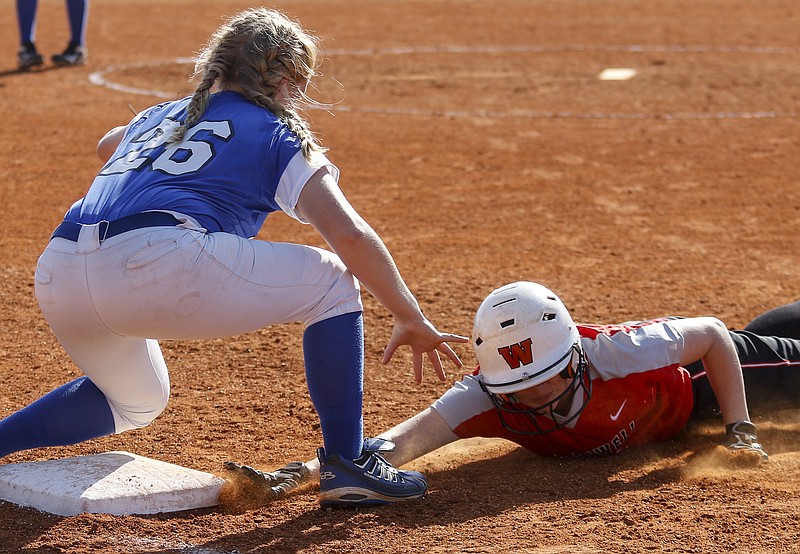Whitwell runner Carley Terry dives back to 1st to avoid the pickoff throw to Sale Creek's Madison Stott during their prep softball game at Whitwell High School on Wednesday, April 26, 2017, in Whitwell, Tenn.