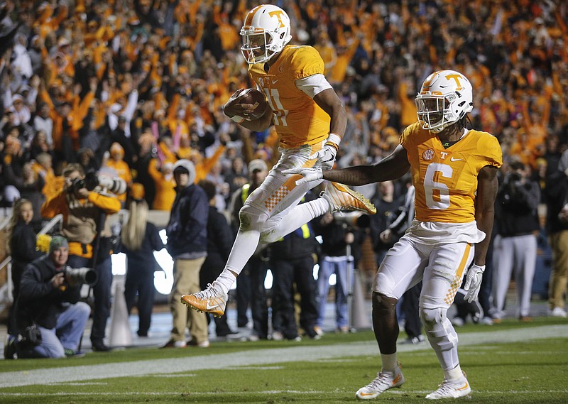 Tennessee quarterback Joshua Dobbs leaps into the end zone ahead of teammate Alvin Kamara for a touchdown during the Vols' home football game against the Missouri Tigers at Neyland Stadium on Saturday, Nov. 19, 2016, in Chattanooga, Tenn. Tennessee won their final home game of the season 63-37.