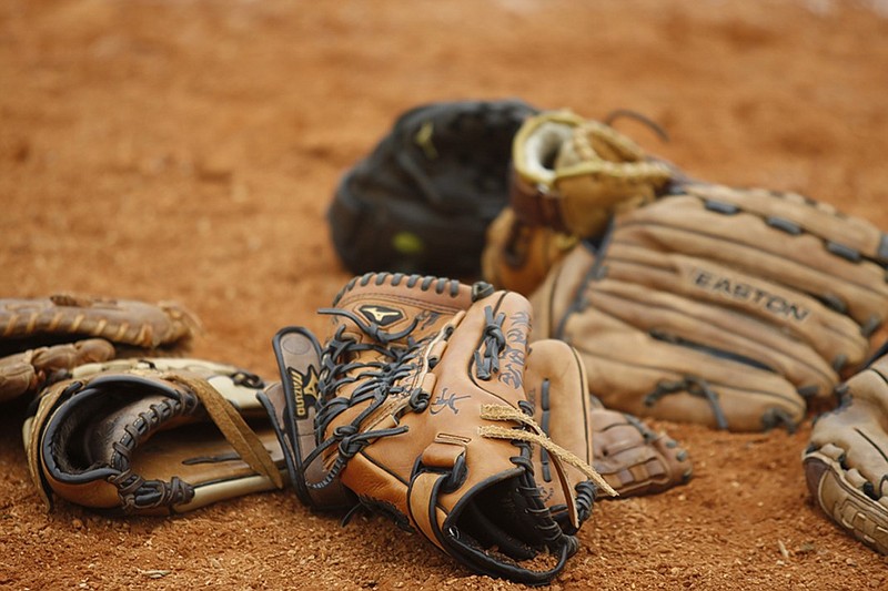 Staff Photo by Doug Strickland/Chattanooga Times Free Press - Gloves lie in a pile in the Lady Trojan Invitational softball tournament Friday, March 29, 2013, in Soddy-Daisy, Tenn.