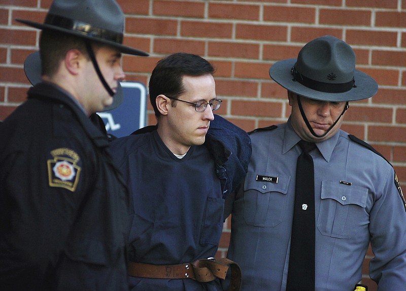 
              FILE - In this Jan. 5, 2015, file photo, Eric Frein is led away by Pennsylvania State Police Troopers at the Pike County Courthouse after his preliminary hearing in Milford, Pa. Prosecutors are seeking the death penalty against Frein, who they said targeted state police because he was trying to foment an uprising against the government. Frein’s lawyers want the jury to sentence him to life without parole. (Butch Comegys/The Times & Tribune via AP, File)
            