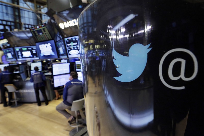 
              FILE - In this Tuesday, Oct. 13, 2015, file photo, the Twitter logo appears on a phone post on the floor of the New York Stock Exchange. Twitter Inc. on Wednesday, April 26, 2017, reported a loss of $61.6 million in its first quarter. (AP Photo/Richard Drew, File)
            