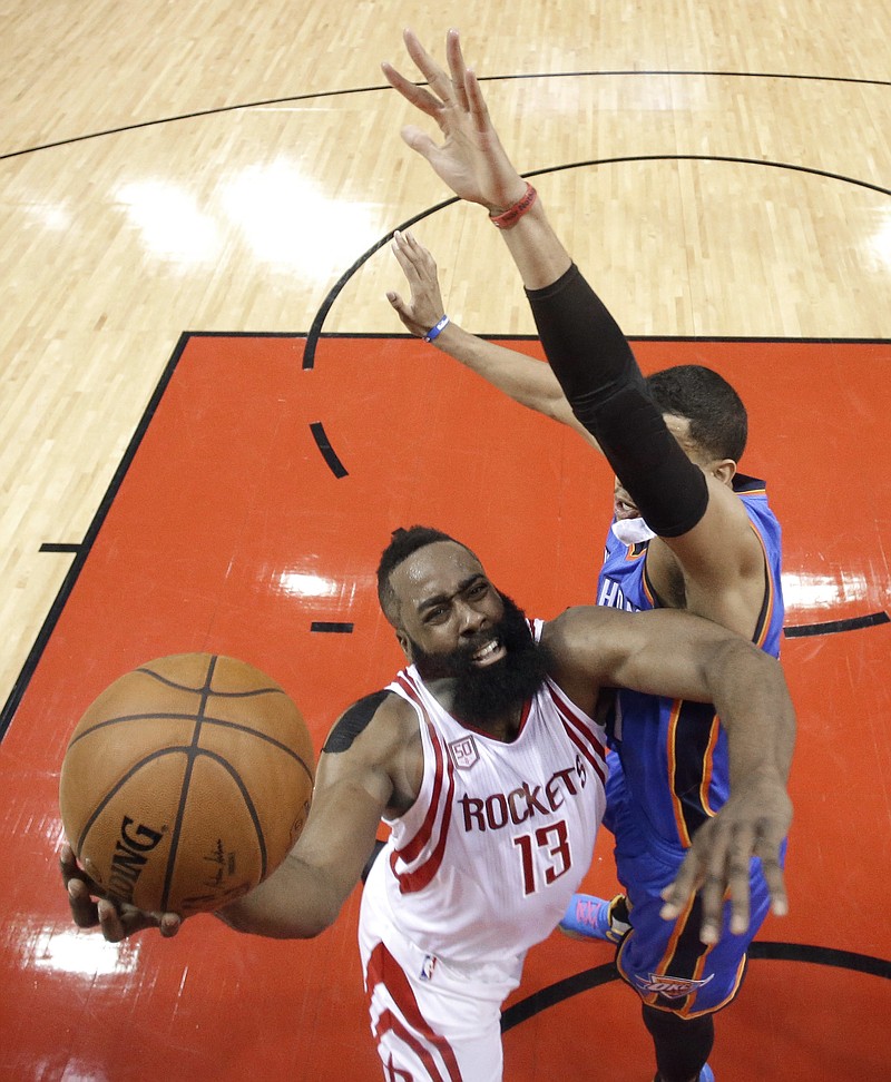 
              Houston Rockets' James Harden (13) goes up for a shot as Oklahoma City Thunder's Andre Roberson defends during the first half in Game 5 of an NBA basketball first-round playoff series, Tuesday, April 25, 2017, in Houston. (AP Photo/David J. Phillip)
            