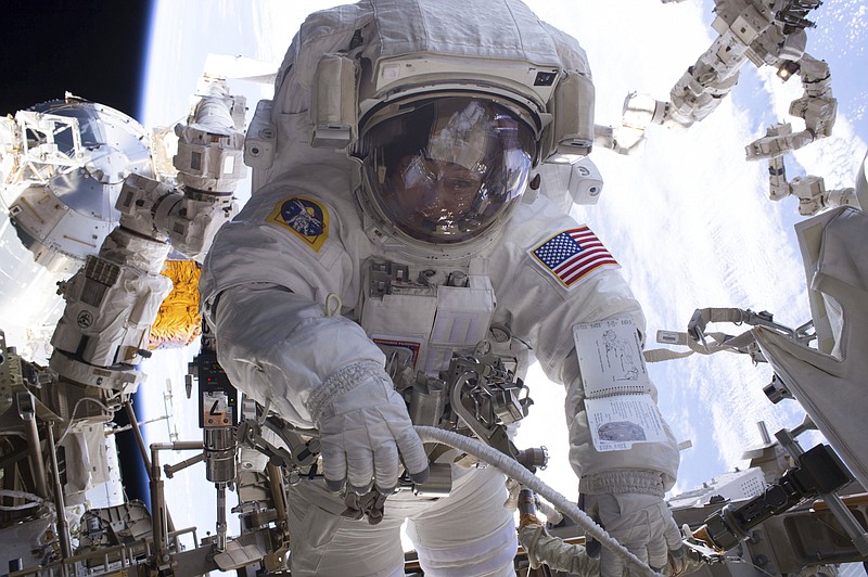 
              In this Jan. 6, 2017 photo made available by NASA, astronaut Peggy Whitson performs a spacewalk during Expedition 50 aboard the International Space Station. According to a report released Wednesday, April 26, 2017, NASA is managing a variety of design and health risks associated with the spacewalking suits used by astronauts aboard the International Space Station. The suits were developed more than 40 years ago and intended for only 15 years' use. (NASA via AP)
            