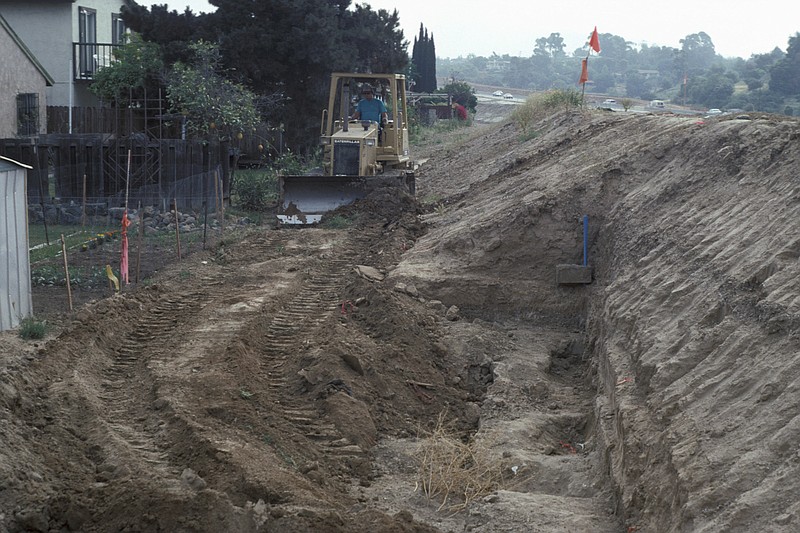 
              In this April 28, 1993 photo provided by the San Diego Natural History Museum, a bulldozer refills the Cerutti Mastodon site in San Diego, Calif., after the excavation and salvage of fossils. In a report released on Wednesday, April 26, 2017, researchers say the southern California site shows evidence of human-like behavior from about 130,000 years ago, when bones and teeth of an elephant-like mastodon were evidently smashed with rocks. (San Diego Natural History Museum via AP)
            