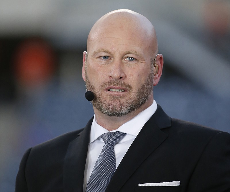 
              FILE - In this Sept. 19, 2016, file photo, Trent Dilfer talks during ESPN's "Monday Night Countdown" before an NFL football game between the Chicago Bears and the Philadelphia Eagles, in Chicago. ESPN is laying off about 100 employees, including former athletes-turned-broadcasters Trent Dilfer, Len Elmore and Danny Kanell, in a purge designed to focus the sports network on a more digital future. The cuts will trim ESPN's stable of on-air talent and writers by about 10 percent. (AP Photo/Charles Rex Arbogast, File)
            