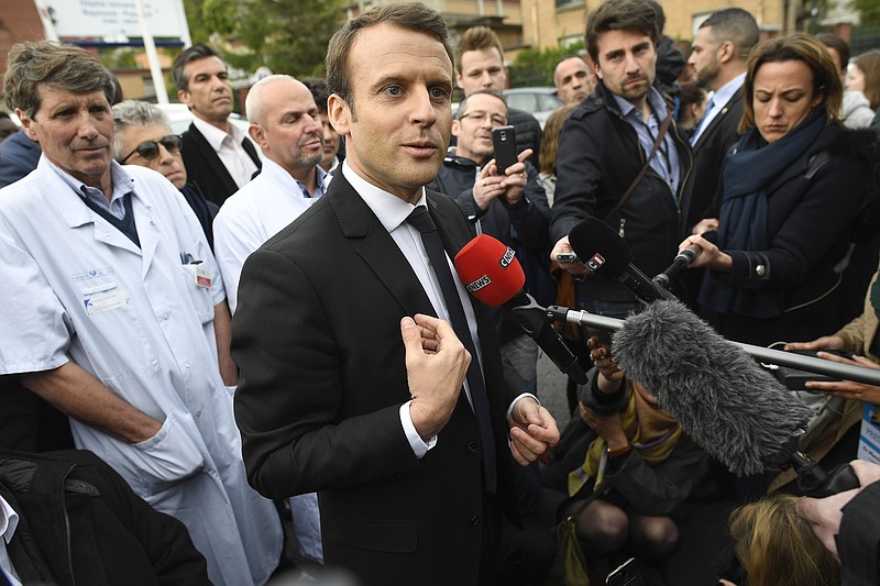 
              French centrist presidential candidate Emmanuel Macron, speaks to journalists after a visit at the Raymond Poincare hospital in Garches, outside Paris, France, Tuesday, April 25, 2017. (Lionel Bonaventure/Pool Photo via AP)
            