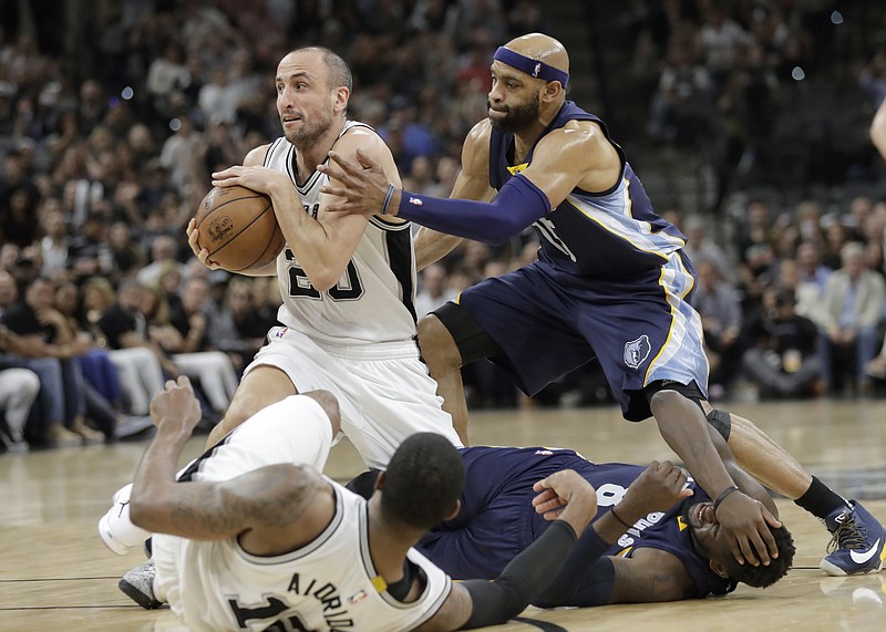 San Antonio Spurs guard Manu Ginobili (20) grabs a loose ball in front of Memphis Grizzlies guard Vince Carter (15) during the first half of Game 5 in a first-round NBA basketball playoff series, Tuesday, April 25, 2017, in San Antonio. (AP Photo/Eric Gay)