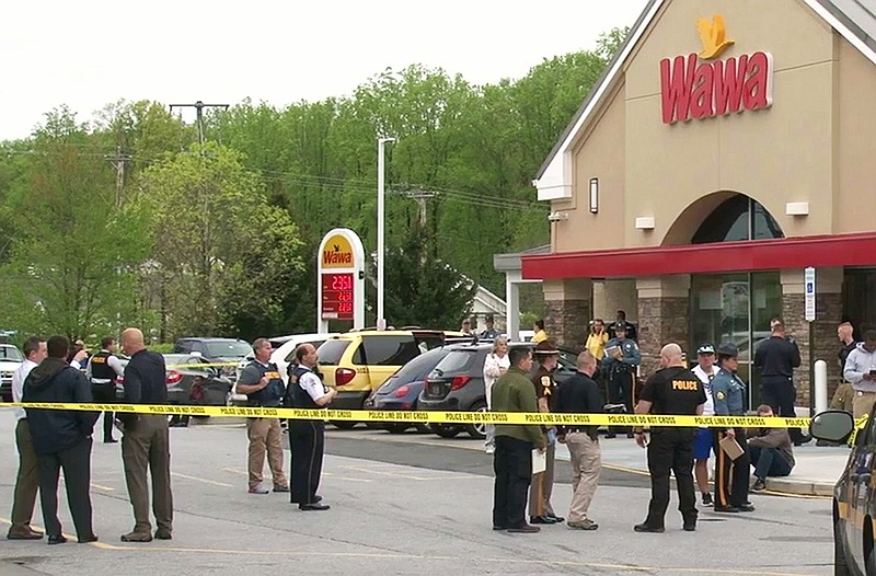 
              Authorities investigate the scene of a shooting, Wednesday, April 26, 2017, in Bear, Del. Delaware State Police say a trooper has been taken to a hospital after being shot at the convenience store. The trooper, who was on duty at the time, was taken to Christiana Hospital. (Damian Giletto/The News Journal via AP)
            