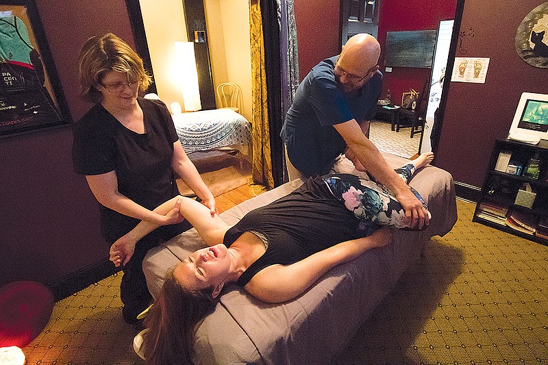 Virginia Lee, with ReVive Bodywork and Massage, performs spine mobility, shoulder and hip work on local competitive swimmer Jamie Ann Phillips while at Lee's Athletic Massage Studio 