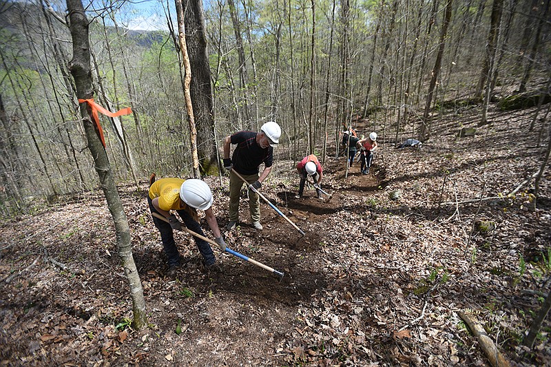 Sara Lewis, Marvin Webb and Charlotte Bossy, from left, with Rock/Creek, work on the Pot Point Trail in March. The sporting goods retailer volunteered its staff to do work on the trail for nine consecutive days.