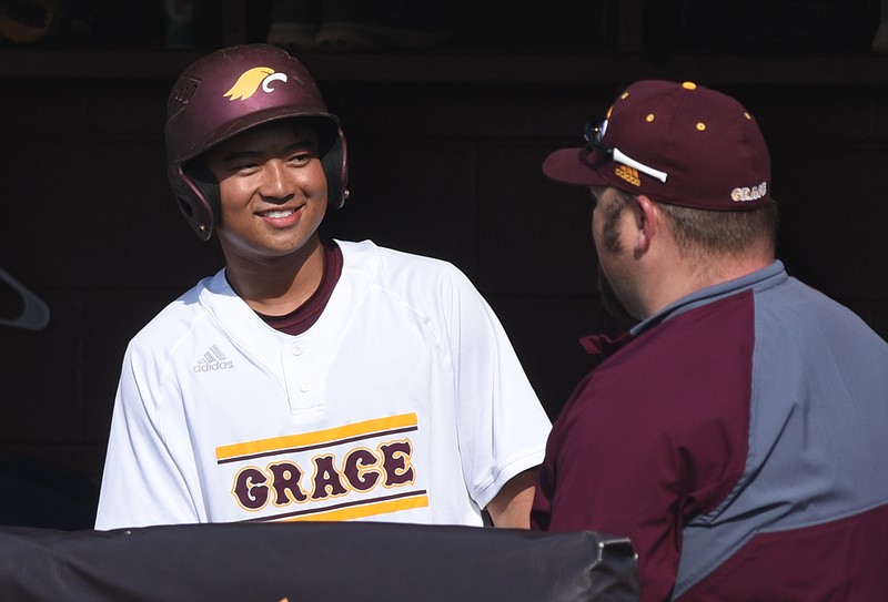Grace Academy's Poa Thithiphagon talks with a coach before batting Thursday, April 13, 2017 in the game against Howard at Grace.