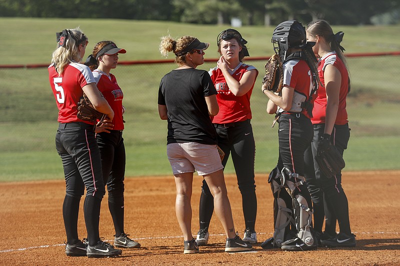 Whitwell softball coach Rebecca Castle conferences with her team in the pitcher's circle during their prep softball game against Sale Creek at Whitwell High School on Wednesday, April 26, 2017, in Whitwell, Tenn.