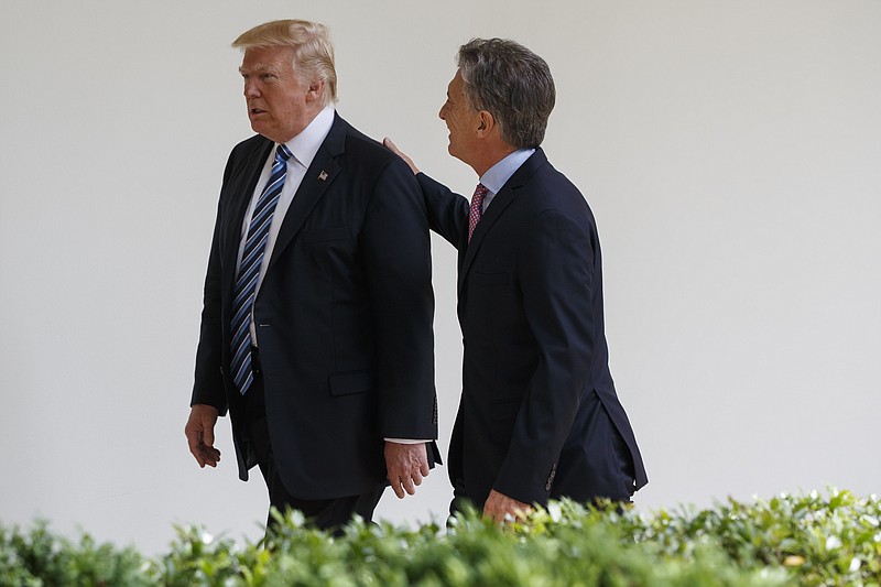 
              President Donald Trump walks with Argentine President Mauricio Macri at the White House in Washington, Thursday, April 27, 2017. (AP Photo/Evan Vucci)
            