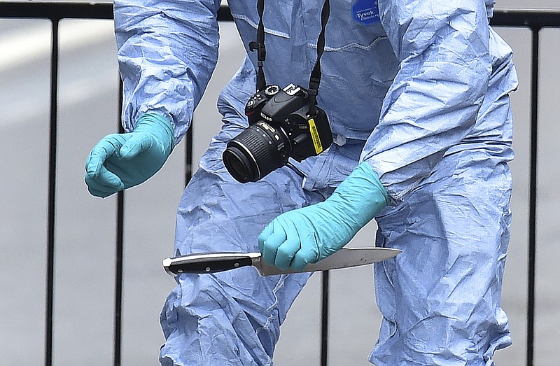 
              A police forensic Officer holds a knife at the scene after a man was arrested following an incident at Whitehall in London, Thursday April 27, 2017.  London police arrested a man for possession of weapons Thursday near Britain’s Houses of Parliament. (Dominic Lipinski/PA via AP)
            