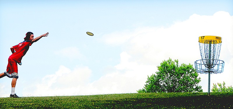 Professional disc golfer James Cole tosses a putter disc during the Tennessee State Championship in 2014. 