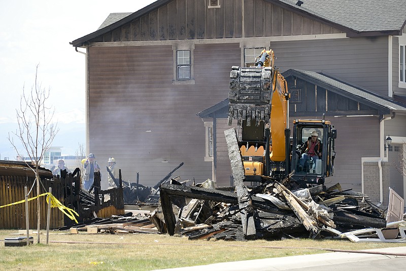 
              In this April 18, 2017, photo, investigators stand by as debris is removed from a house that was destroyed in a deadly explosion in Firestone, Colo., on April 17. Anadarko Petroleum said Wednesday, April 26, that it operated a well about 200 feet (60 meters) from the house in the town of Firestone. The company didn't say whether the well was believed to be a factor in the explosion or whether it produced oil, gas or both. (Matthew Jonas/The Daily Times Call via AP)
            