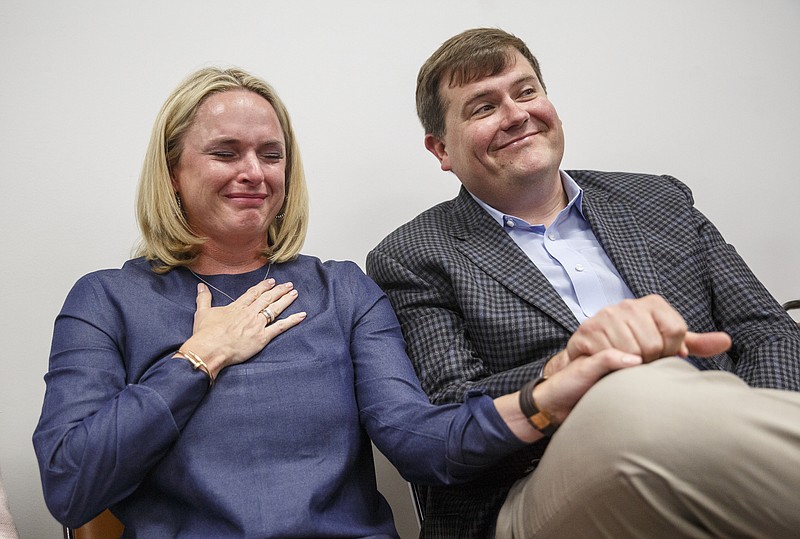 Kelly Alling, left, and her husband, Ted Alling, shed tears as the Chattanooga Preparatory School they want to start is approved by the Hamilton County Board of Education.
