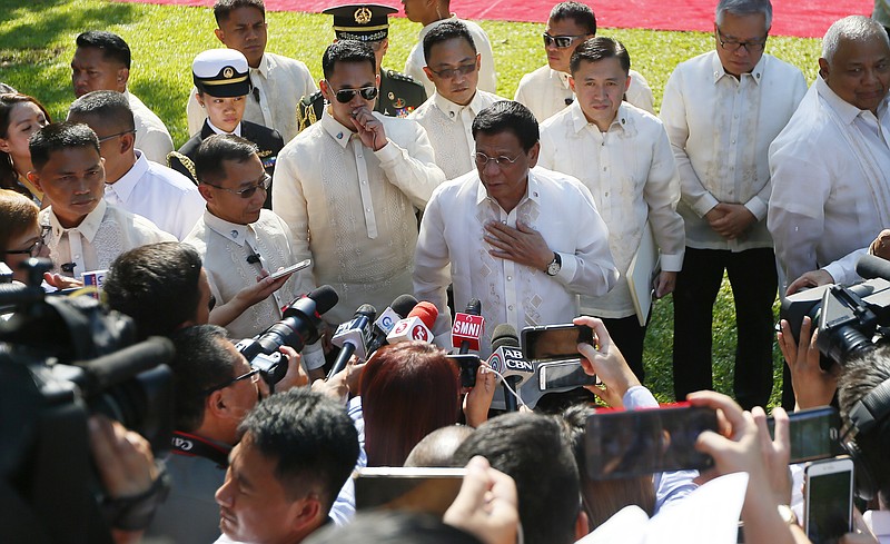 
              Philippine President Rodrigo Duterte talks to the media prior to a welcoming ceremony for Indonesian President Joko Widodo, at Malacanang Palace grounds in Manila, Philippines Friday, April 28, 2017. When Duterte hosts a summit of Southeast Asian leaders this weekend, the spotlight will be on him. Just less than a year in power, Duterte faces a mass murder complaint before the International Criminal Court and an impeachment bid at home as bodies continue to pile up in his war on illegal drugs.(AP Photo/Bullit Marquez)
            