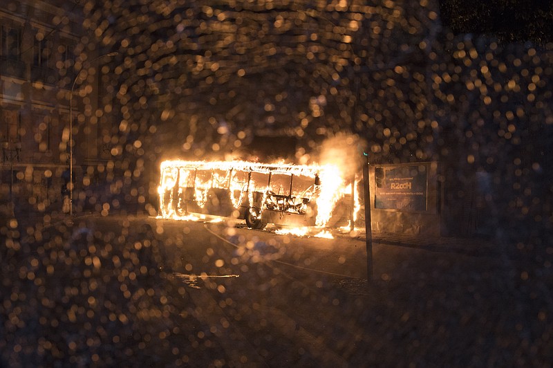 
              Seen through a shattered bus window, another bus burns after it was set fire by protesters during a general strike in Rio de Janeiro, Brazil, Friday, April 28, 2017. Public transport largely came to a halt across much of Brazil on Friday and protesters blocked roads and scuffled with police as part of a general strike to protest proposed changes to labor laws and the pension system. (AP Photo/Leo Correa)
            