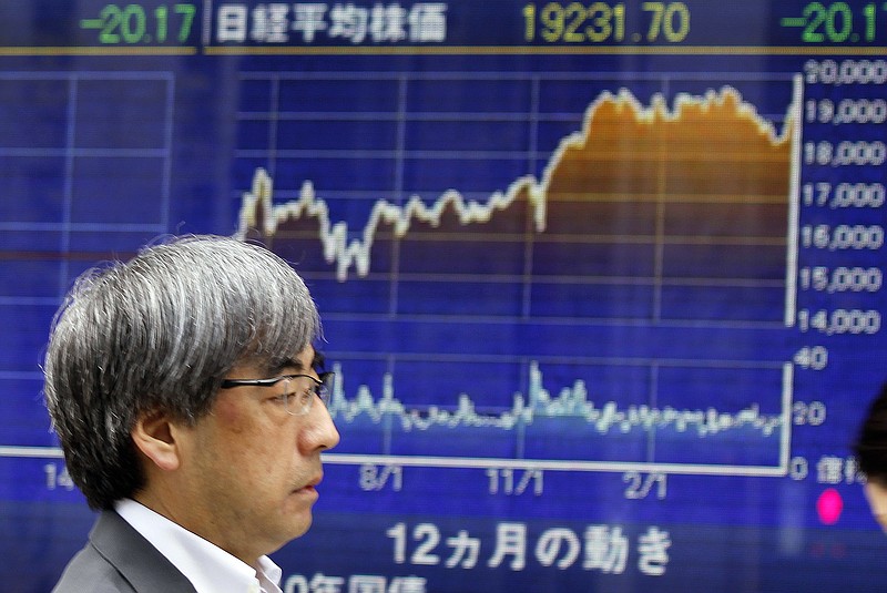 
              A man walks past an electronic stock board showing Japan's Nikkei 225 index at a securities firm in Tokyo, Friday, April 28, 2017. Asian stocks were mostly lower Friday amid jitters over North Korea and conflicting signals from President Donald Trump about U.S. trade policy. 
(AP Photo/Shuji Kajiyama)
            
