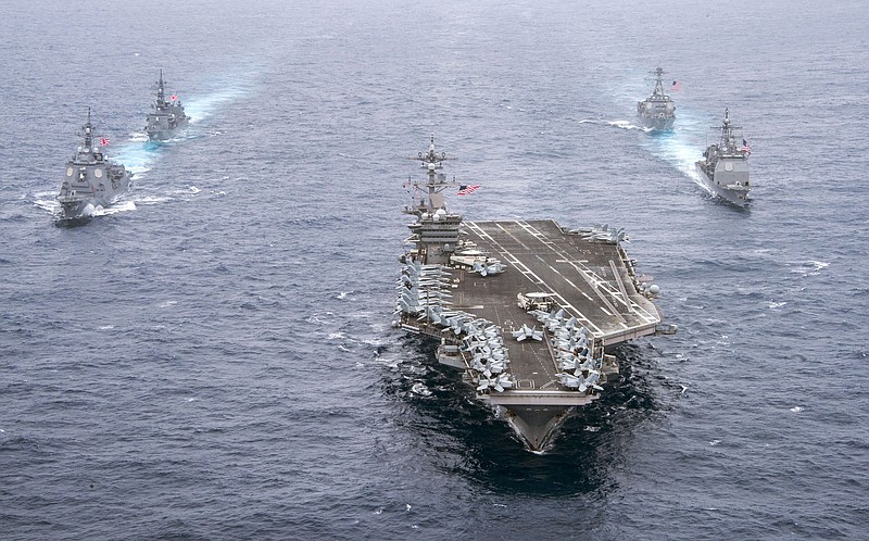 In this Wednesday, April 26, 2017 photo released by the U.S. Navy, the aircraft carrier USS Carl Vinson, center, leads the U.S. Navy guided-missile cruiser USS Lake Champlain, right front, and the Arleigh Burke-class guided-missile destroyer USS Michael Murphy with the Japan Maritime Self-Defense Force Atago-class guided-missile destroyer JS Ashigara, left front, and the JMSDF Murasame-class destroyer JS Samidare during a transit of the Philippine Sea toward the Korean Peninsula for an exercise with South Korea. (Mass Communication Specialist 2nd Class Sean M. Castellano/U.S. Navy via AP)