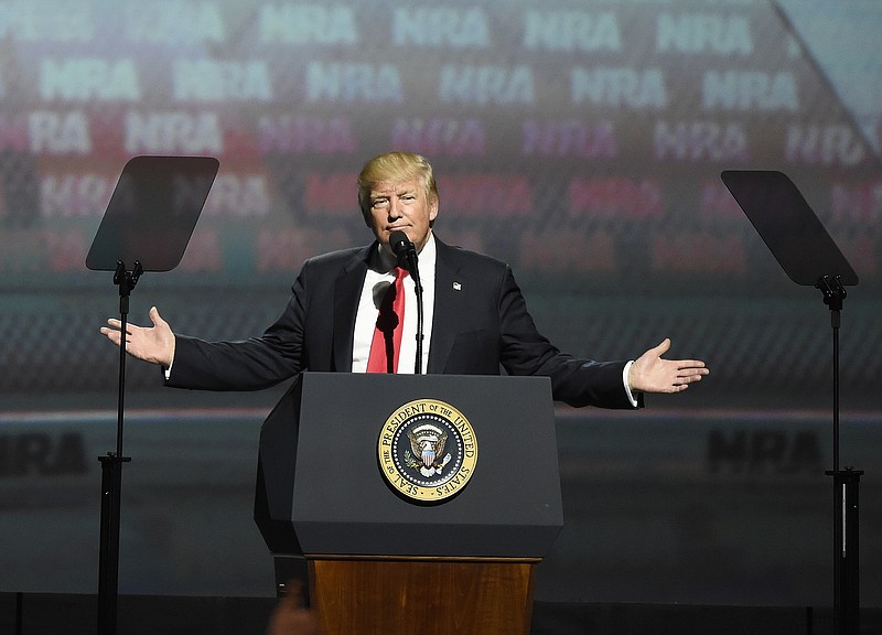 President Donald Trump gestures as he speaks at the National Rifle Association-ILA Leadership Forum, Friday, April 28, 2017, in Atlanta. The NRA is holding its 146th annual meetings and exhibits forum at the Georgia World Congress Center. (AP Photo/Mike Stewart)