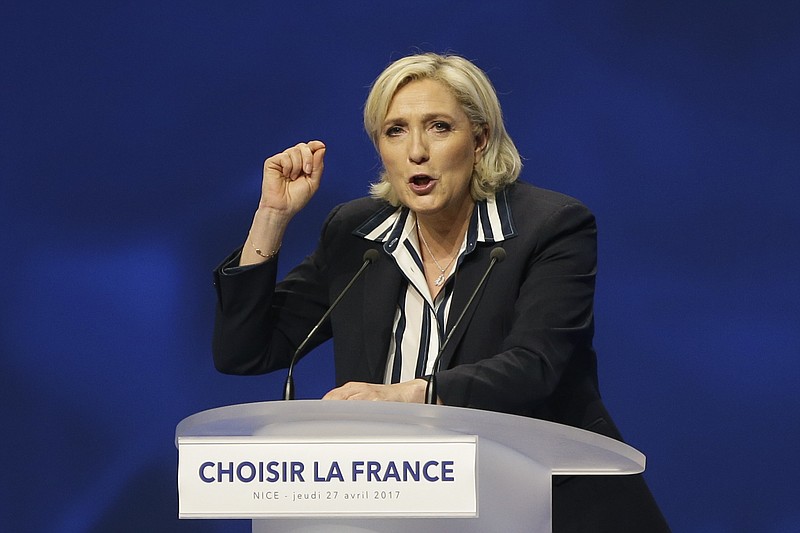 
              French far-right leader and presidential candidate Marine Le Pen addresses supporters during an election campaign rally in Nice, southern France, Thursday April 27, 2017. After "the battle of Whirlpool," when Marine Le Pen and Emmanuel Macron both went hunting for France's blue-collar vote at a threatened home appliance factory, the presidential candidates clashed over fish as Le Pen boarded a fishing trawler, in a return to more traditional campaigning on Thursday. (AP Photo/Claude Paris)
            