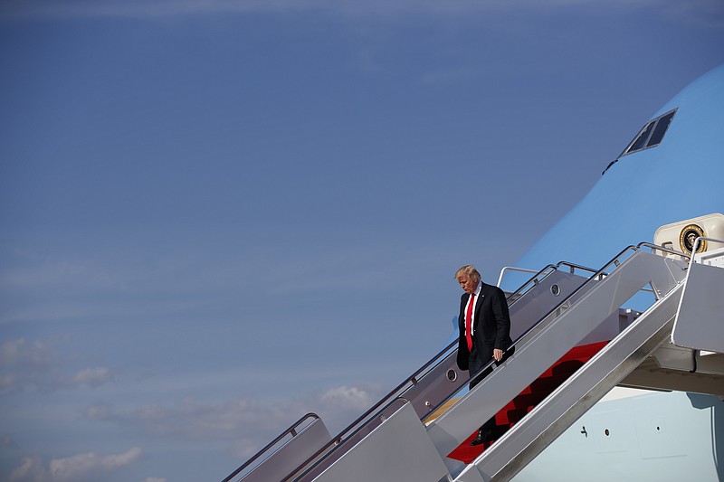 
              President Donald Trump walks down the steps of Air Force One after arriving at Andrews Air Force Base, MD., Friday, April 28, 2017. President Trump is returning from addressing the National Rifle Association convention in Atlanta.  (AP Photo/Evan Vucci)
            