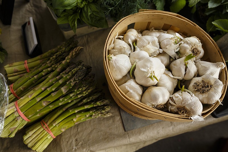 Asparagus and garlic are sold by White City Produce and Greenhouses on the opening day of the Chattanooga Market at the First Tennessee Pavilion on Saturday, April 29, 2017, in Chattanooga, Tenn. The annual market features local vendors selling art, crafts, produce and artisan goods on Sundays until the fall.
