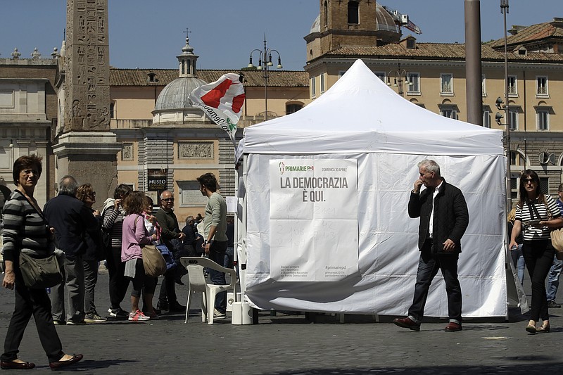 
              Citizens line up at a makeshift gazebo set up around the country for the Democratic party's primary elections, in Rome Sunday, April 30, 2017. Italians are voting for a new leader of the Democratic Party in a primary expected to give Matteo Renzi a fresh mandate. Challenging him in the primary are Justice Minister Andrea Orlando and Michele Emiliano, who is governor of the southern region of Puglia. (AP Photo/Alessandra Tarantino)
            