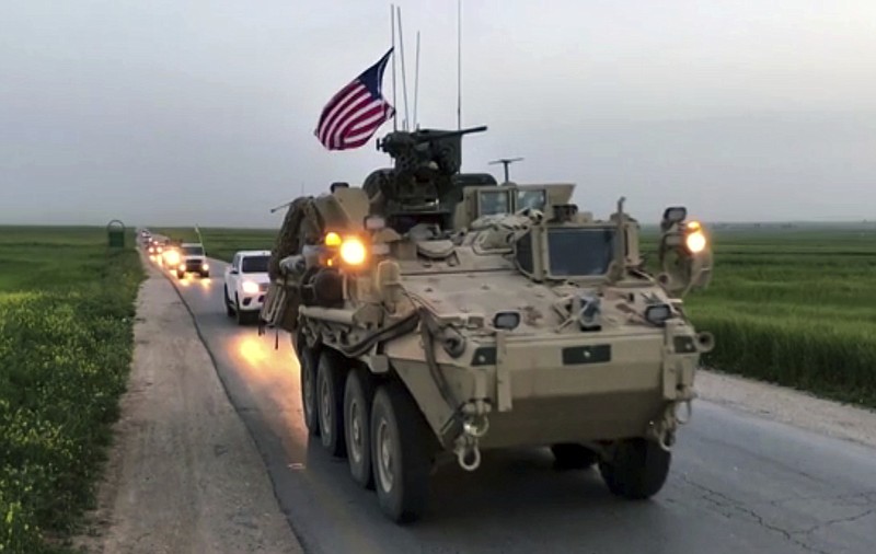 
              This Friday, April 28, 2017 still taken from video, shows U.S. forces patrolling on a rural road in the village of Darbasiyah, in northern Syria. U.S. armored vehicles are deploying in areas in northern Syria along the tense border with Turkey, a few days after a Turkish airstrike that killed 20 U.S.-backed Kurdish fighters, a Syrian war monitor and Kurdish activists said Friday. (AP Photo via APTV)
            