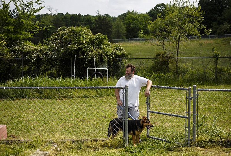 Times Free Press file photo / Kevin Key stands with a dog after it was met by a family for potential adoption at the Walker County Animal Shelter in Chickamauga, Ga.