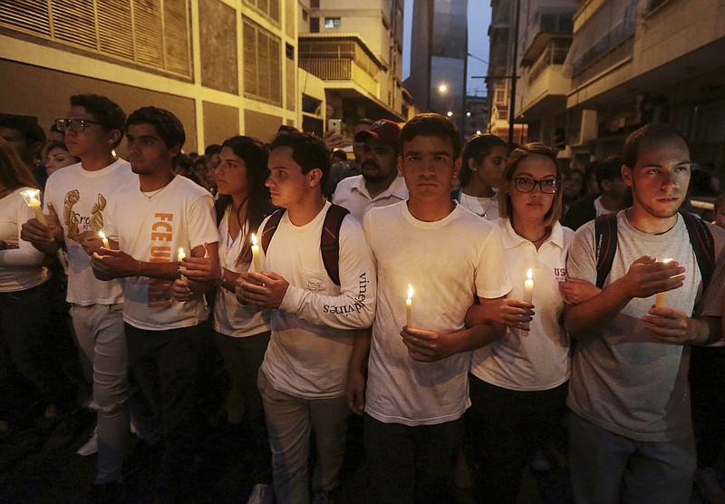 
              University students hold a candlelight vigil for their late classmate Juan Pablo Pernalete in Caracas, Venezuela, Saturday, April 29, 2017. Students commemorated Pernalete who was killed this week by security forces during an anti-government protest. (AP Photo/Fernando Llano)
            