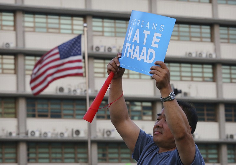 
              A South Korean protester holds up a card during a rally to oppose a plan to deploy the advanced U.S. missile defense system called Terminal High-Altitude Area Defense, or THAAD, near U.S. Embassy in Seoul, South Korea, Saturday, April 29, 2017. A North Korean mid-range ballistic missile apparently failed shortly after launch Saturday, South Korea and the United States said. (AP Photo/Ahn Young-joon)
            