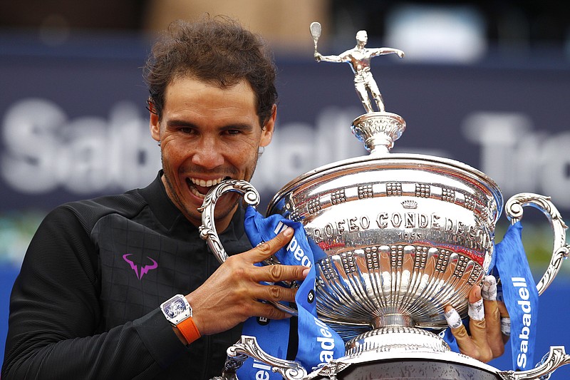 
              Rafael Nadal of Spain poses with the trophy after winning his men's finals match 6-4, 6-1 against Dominic Thiem of Austria during their singles final match at the Barcelona Open Tennis Tournament in Barcelona, Spain, Sunday, April 30, 2017. (AP Photo/Manu Fernandez)
            