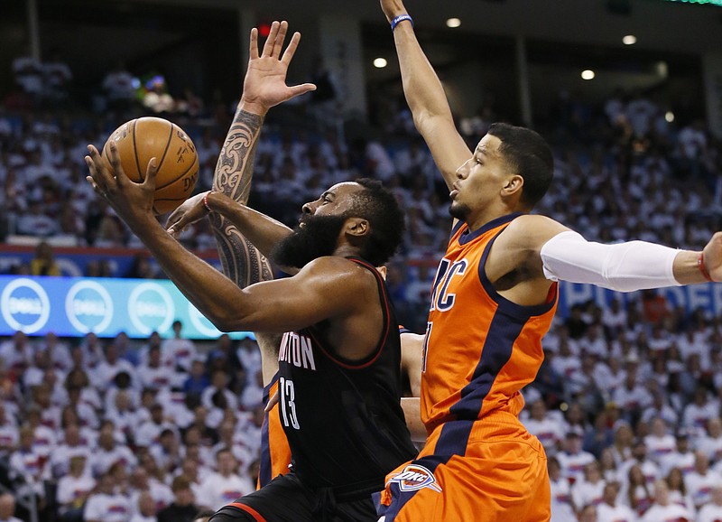 
              FILE - In this Sunday, April 23, 2017, file photo, Houston Rockets guard James Harden, center, goes up for a shot between Oklahoma City Thunder center Steven Adams, rear, and forward Andre Roberson, right, in the first quarter of Game 4 of a first-round NBA basketball playoff series in Oklahoma City. After surviving an intense, physical battle with the Memphis Grizzlies, the San Antonio Spurs now face the freewheeling Houston Rockets. With MVP candidate James Harden leading the Rockets’ offense, Houston averaged 112.8 points in its five-game series against Oklahoma City. (AP Photo/Sue Ogrocki, File)
            