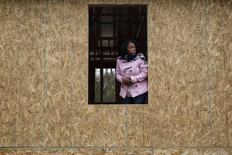 LaToya Little looks out at the foundation of her future home before the groundbreaking of a new Habitat for Humanity home in the Glass Farms neighborhood near Brainerd earlier this year. Proceeds from the ReStore sales and donations directly benefit such homes.