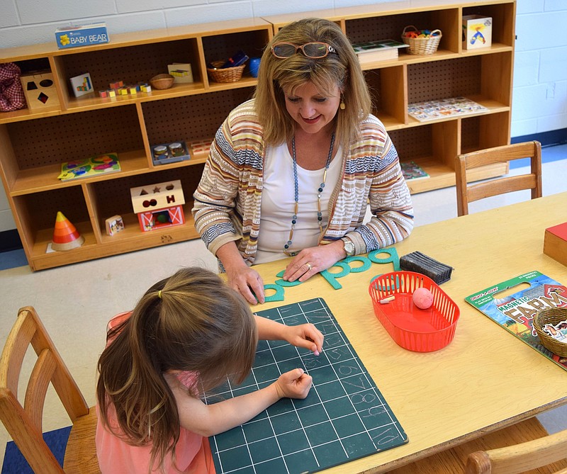 New St. Augustine Learning Center Director Shannon Conway works with students at the preschool, which emphasizes "playing with purpose" and a hands-on approach to learning.