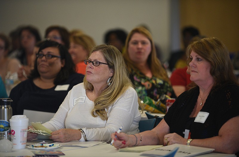 Donna Shields, right, and Belinda Morgan listen as Dr. Pat Levitt speaks Monday, May 1, 2017 during the ACEs Community Summit at the Family Justice Center.