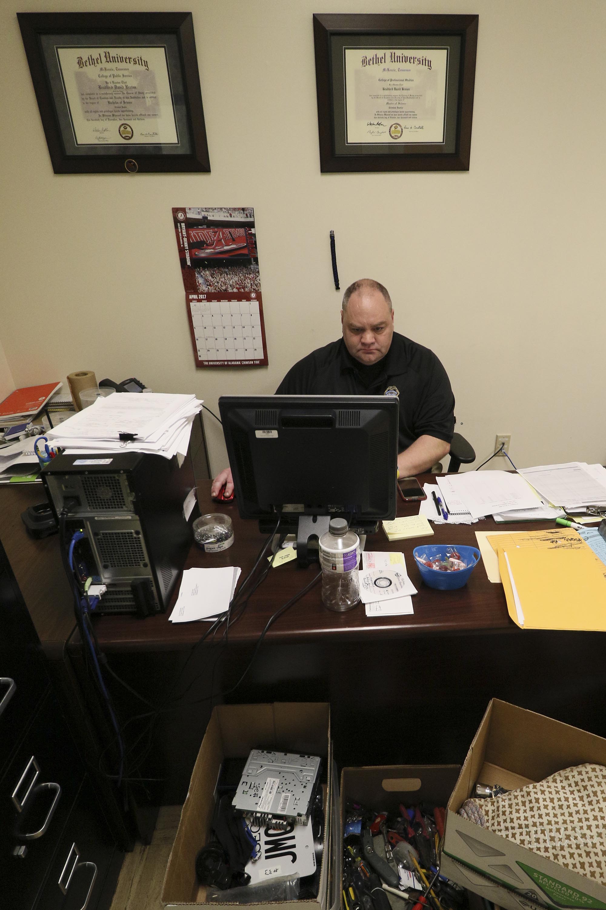 Staff Photo by Dan Henry / The Chattanooga Times Free Press- 4/27/17. Detective Brad Brown works on sorting evidence that was found in recent car and storage unit break ins while in his office at the CPD on Thursday, April 27, 2017.