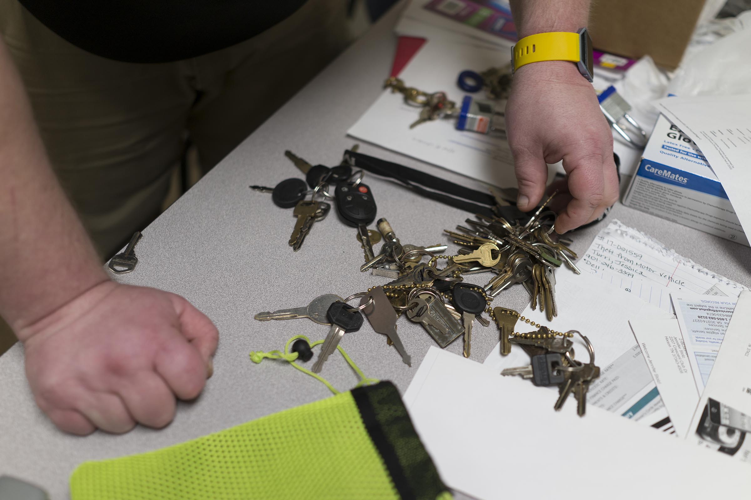 Staff Photo by Dan Henry / The Chattanooga Times Free Press- 4/27/17. Detective Brad Brown works on sorting evidence that was found in recent car and storage unit break ins while in his office at the CPD on Thursday, April 27, 2017.