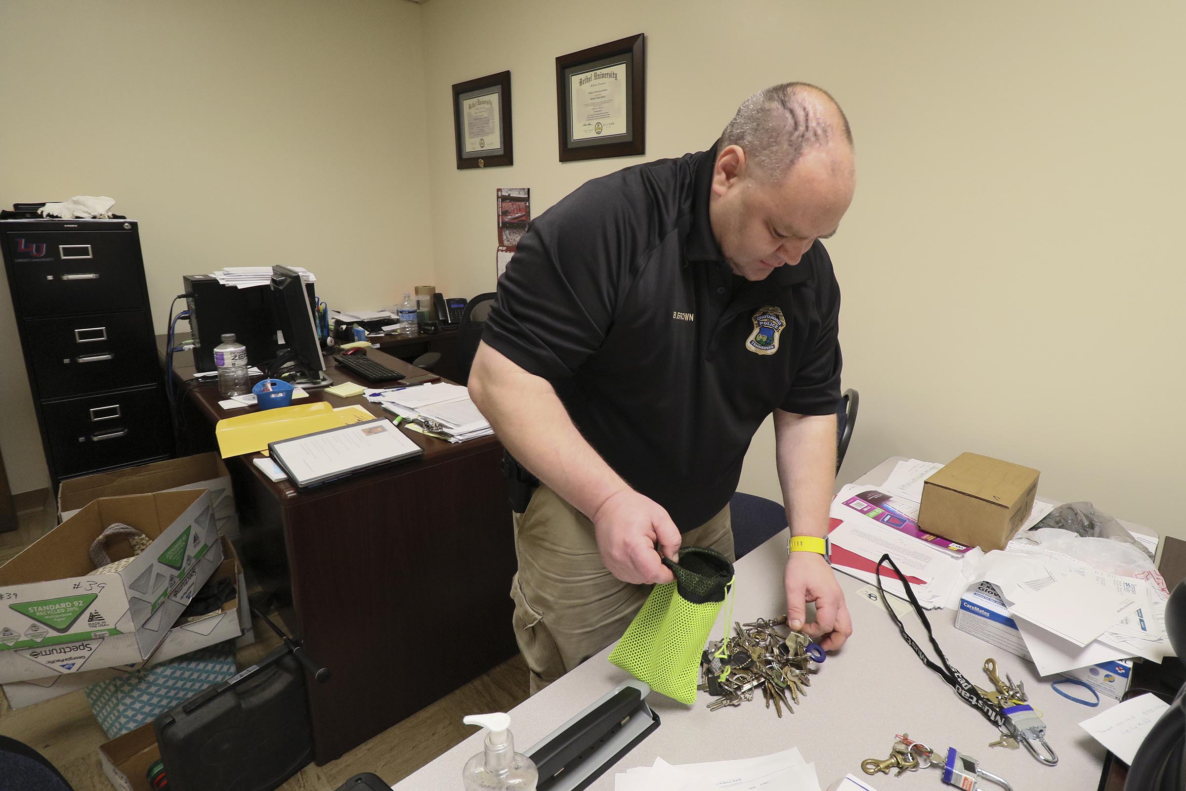 Staff Photo by Dan Henry / The Chattanooga Times Free Press- 4/27/17. Detective Brad Brown works on sorting evidence that was found in recent car and storage unit break ins while in his office at the CPD on Thursday, April 27, 2017.
