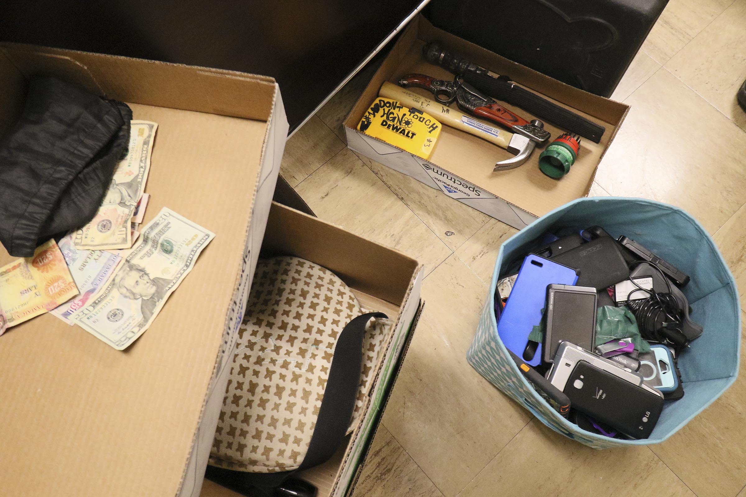 Staff Photo by Dan Henry / The Chattanooga Times Free Press- 4/27/17. Detective Brad Brown works on sorting evidence that was found in recent car and storage unit break ins while in his office at the CPD on Thursday, April 27, 2017.