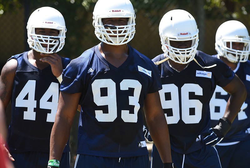 Defensive lineman Toyvian Brand, Keionta Davis and Vantrell McMillan, from left, participate in the first day of football practice for the University of Tennessee at Chattanooga on Monday, Aug. 3, 2015, in Chattanooga, Tenn.
