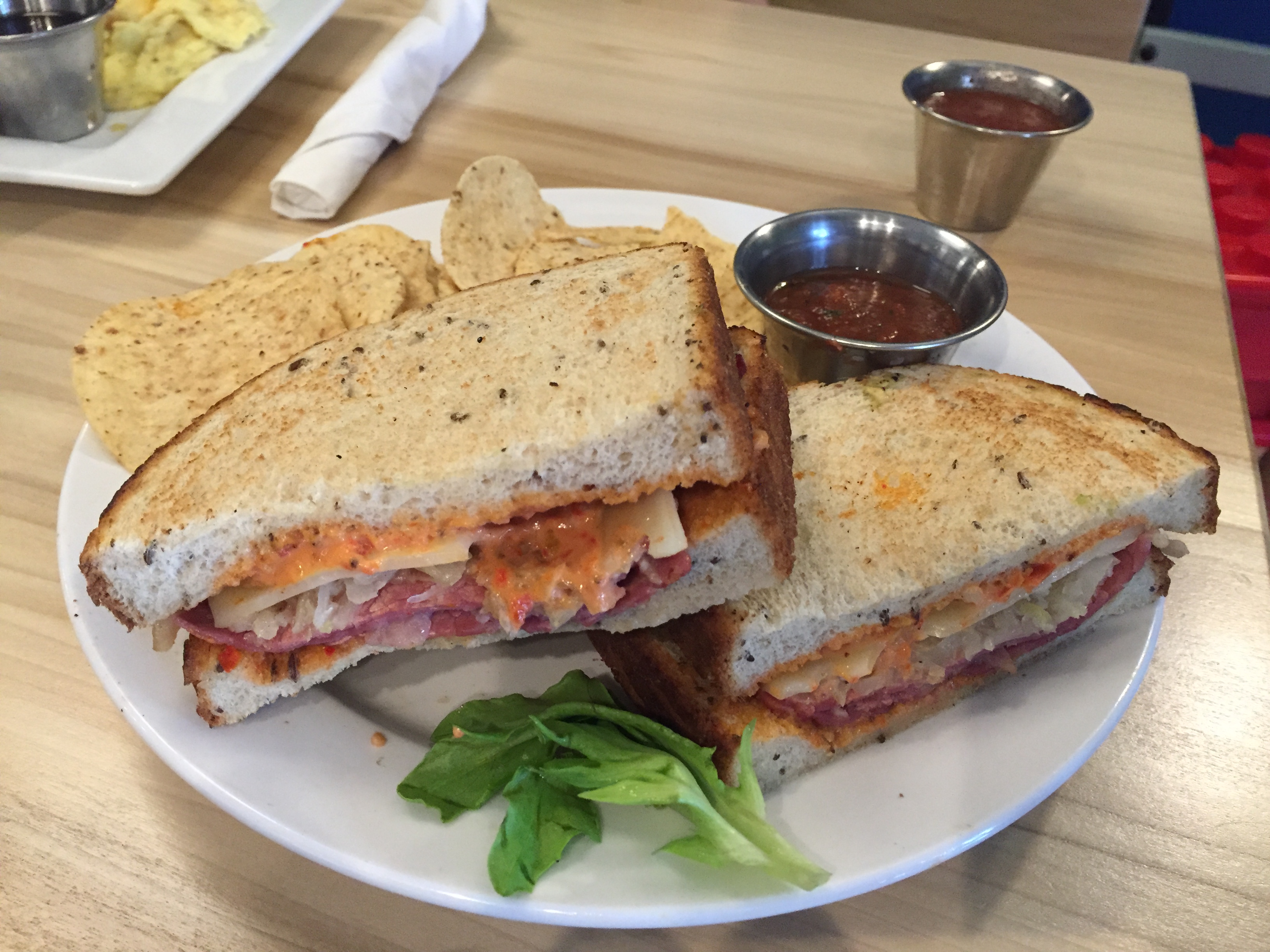 The Buck is Frothy Monkey's take on a Reuben, with corned beef, Swiss cheese, sauerkraut, sun-dried tomatoes and a special sauce served warm on toasted rye. Sandwiches come with corn chips and house-made salsa.