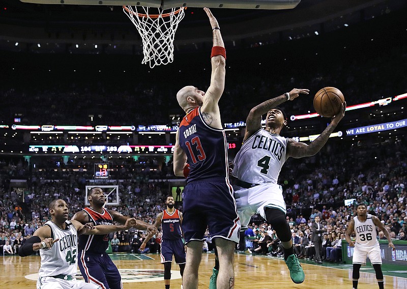 Boston Celtics guard Isaiah Thomas (4) shoots over Washington Wizards center Marcin Gortat (13) during the second half of a second-round NBA playoff series basketball game in Boston, Tuesday, May 2, 2017. Thomas scored 53 as the Celtics defeated the Wizards 129-119 in overtime, taking a 2-0 lead in the series. (AP Photo/Charles Krupa)