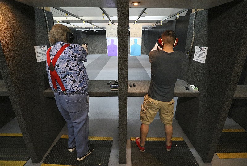 Staff Photo by Dan Henry / The Chattanooga Times Free Press- 4/28/17. Gary Proy celebrates his 71st birthday shooting guns with his grandson Chenaniah Lewis while at Shooter's Depot on April 28, 2017. 